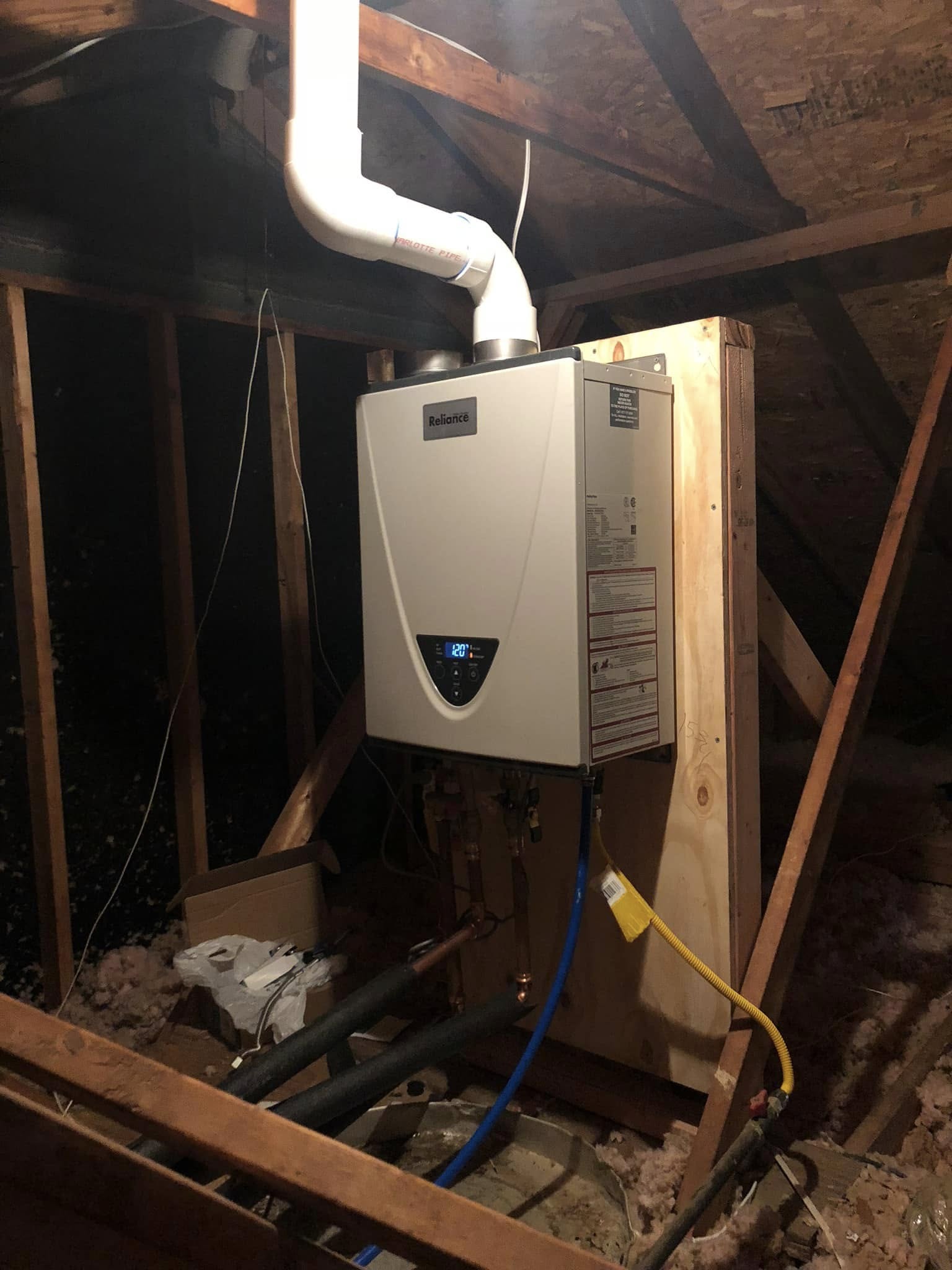 Reliance tankless water heater installed in an attic