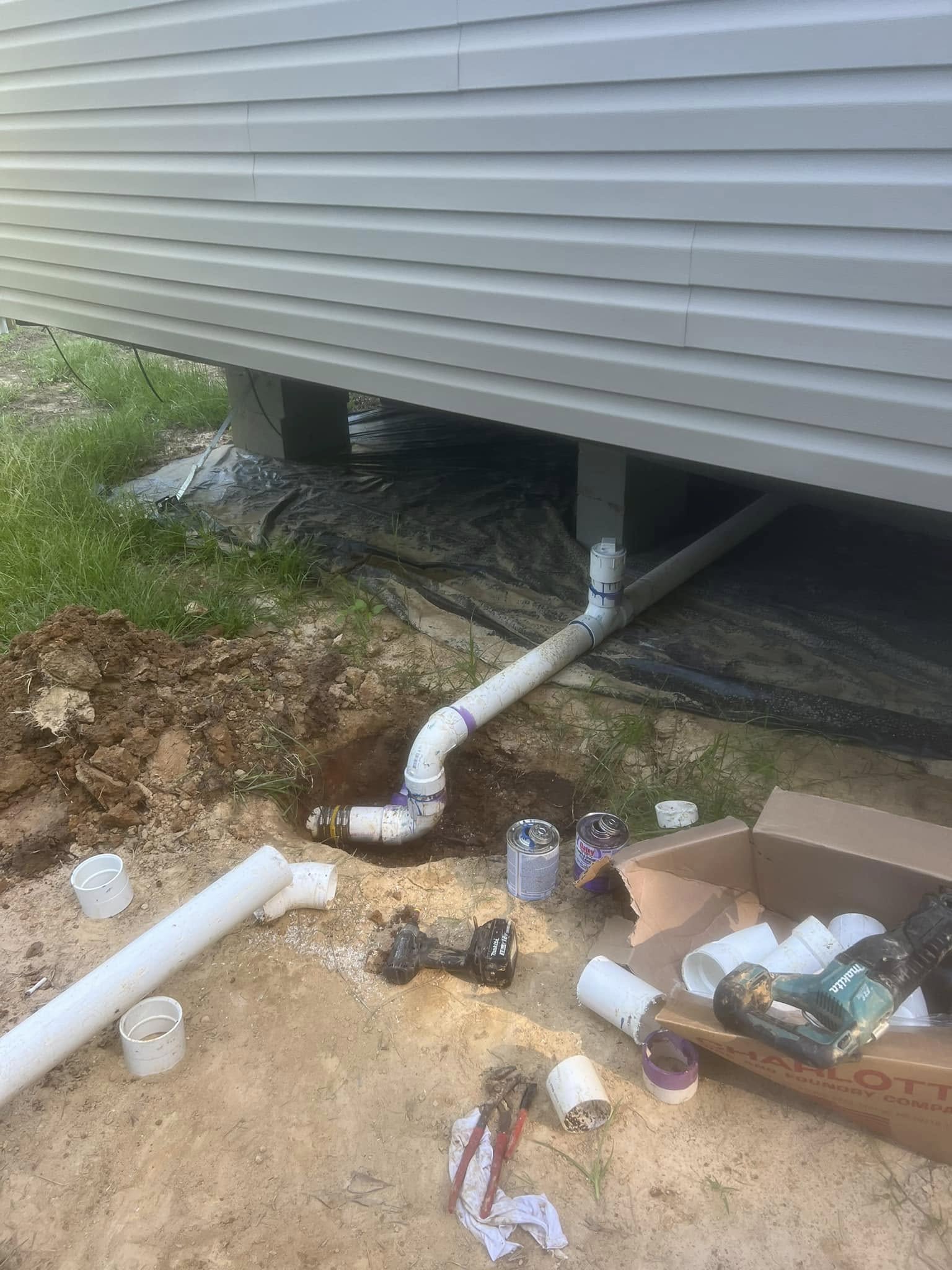 New PVC drain line run under a home